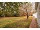 Large backyard with brick walkway and trees at 135 Weatherbend, Pittsboro, NC 27312
