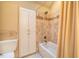Bathroom with white cabinets, beige tile, and bathtub at 135 Weatherbend, Pittsboro, NC 27312