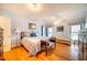 Spacious bedroom with hardwood floors, large bed, and sitting area at 135 Weatherbend, Pittsboro, NC 27312