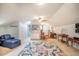 Spacious bonus room with kitchenette and large area rug at 135 Weatherbend, Pittsboro, NC 27312