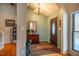 Bright entryway with hardwood floors, featuring a decorative mirror at 135 Weatherbend, Pittsboro, NC 27312