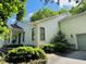 Exterior elevation showcasing a charming home with a well-manicured lawn and mature landscaping at 135 Weatherbend, Pittsboro, NC 27312