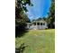 Single story home with a welcoming covered front porch, set among mature trees and lush green grass at 135 Weatherbend, Pittsboro, NC 27312