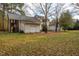 Rear view of house, detached garage, and large yard at 135 Weatherbend, Pittsboro, NC 27312