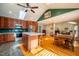 Open kitchen with island, hardwood floors and view into living area at 135 Weatherbend, Pittsboro, NC 27312