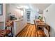 Small galley kitchen with white cabinets and wood flooring at 135 Weatherbend, Pittsboro, NC 27312