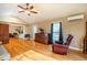 Open living room with hardwood floors, ceiling fan and access to a deck at 135 Weatherbend, Pittsboro, NC 27312