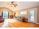 Bright living room with vaulted ceiling, hardwood floors, and a view of the outdoors at 135 Weatherbend, Pittsboro, NC 27312