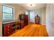 Home office with hardwood floors, large desk, and built-in shelving at 135 Weatherbend, Pittsboro, NC 27312