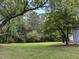 Expansive and well-maintained yard with mature trees, perfect for outdoor enjoyment and relaxation at 135 Weatherbend, Pittsboro, NC 27312