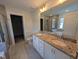 Bathroom featuring double sink vanity with granite countertop and gray decorative backsplash at 150 Steppe Way, Garner, NC 27529