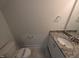 Powder room featuring a granite countertop, white vanity, and modern fixtures at 150 Steppe Way, Garner, NC 27529