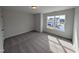 Bright bedroom featuring carpet and a window overlooking the neighborhood at 150 Steppe Way, Garner, NC 27529
