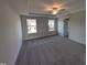 A carpeted bedroom with a ceiling fan and windows providing an abundance of natural light at 150 Steppe Way, Garner, NC 27529