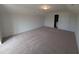 Spacious bonus room with plush carpeting and ample natural light, perfect for a home office or play area at 150 Steppe Way, Garner, NC 27529