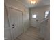 Bright entryway with light-colored flooring, and a coat closet at 150 Steppe Way, Garner, NC 27529