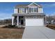 Two-story home featuring stone accents, a two-car garage, and an 'available' sign at 150 Steppe Way, Garner, NC 27529
