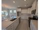 Kitchen with stainless-steel appliances, white cabinetry and large island at 150 Steppe Way, Garner, NC 27529
