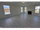 Living room featuring large windows, a fireplace, and light-colored flooring at 150 Steppe Way, Garner, NC 27529