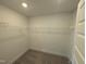 Spacious walk-in closet with white wire shelving and carpet floors at 150 Steppe Way, Garner, NC 27529