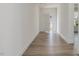 Hallway with beautiful flooring leading to an open door and view of the outdoors at 188 Shelby Meadow Ln, Angier, NC 27501