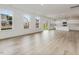 Bright open-concept living area with wood-look floors, large windows, and a view into the kitchen at 188 Shelby Meadow Ln, Angier, NC 27501