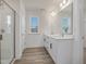 Bright bathroom with a double sink vanity, large mirror, and glass enclosed shower at 199 Shelby Meadow Ln, Angier, NC 27501