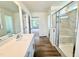 Bright bathroom with a white vanity, glass-enclosed shower, and views into an adjacent bedroom at 199 Shelby Meadow Ln, Angier, NC 27501