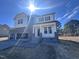 Beautiful two-story home with stone accents, a welcoming front porch, and a spacious three-car garage at 199 Shelby Meadow Ln, Angier, NC 27501