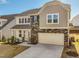 Charming two-story home featuring stone accents and a convenient two-car garage at 199 Shelby Meadow Ln, Angier, NC 27501