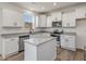 Bright kitchen featuring white cabinets, stainless steel appliances, granite countertops, and center island at 199 Shelby Meadow Ln, Angier, NC 27501