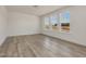 Bright living room with wood-look floors and large windows that offer neighborhood views at 199 Shelby Meadow Ln, Angier, NC 27501