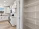 Bright pantry with wire shelving, located off a kitchen with stainless steel appliances and granite countertops at 199 Shelby Meadow Ln, Angier, NC 27501