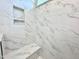 Elegant shower showcasing marble-patterned tile, built-in niche, and a comfortable bench at 199 Shelby Meadow Ln, Angier, NC 27501