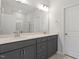 Bathroom with double vanity, gray cabinets, and a large mirror at 281 Chesapeake Commons St # 95, Garner, NC 27529