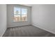 A carpeted bedroom offers natural light through a window with green treetop views at 281 Chesapeake Commons St # 95, Garner, NC 27529