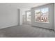 Bright bedroom with neutral carpet and large windows showcasing the neighborhood at 281 Chesapeake Commons St # 95, Garner, NC 27529