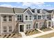 Attractive townhome featuring brick and gray siding, complemented by manicured landscaping and a welcoming entrance at 281 Chesapeake Commons St # 95, Garner, NC 27529