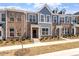 New townhome featuring brick accents, gray siding, manicured landscaping and a welcoming front entrance at 281 Chesapeake Commons St # 95, Garner, NC 27529
