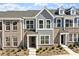 A modern townhome showcasing a stylish mix of brick and siding with a well-maintained front yard at 281 Chesapeake Commons St # 95, Garner, NC 27529