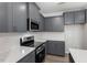 Modern kitchen features gray cabinets, stainless steel appliances, quartz countertops, and subway tile backsplash at 281 Chesapeake Commons St # 95, Garner, NC 27529
