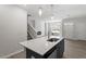 Stylish kitchen with gray cabinets, stainless steel appliances, island with quartz countertop, and pendant lighting at 281 Chesapeake Commons St # 95, Garner, NC 27529