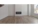 Bright living room with light wood floors and a modern, minimalist fireplace at 281 Chesapeake Commons St # 95, Garner, NC 27529