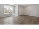 Bright, open-plan living space featuring light gray flooring, neutral walls, and a view of exterior townhomes at 281 Chesapeake Commons St # 95, Garner, NC 27529