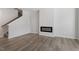 Bright living room with light wood floors and a modern, minimalist fireplace at 281 Chesapeake Commons St # 95, Garner, NC 27529