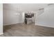 A contemporary living space featuring gray wood floors, light gray walls, open to the kitchen and staircase at 281 Chesapeake Commons St # 95, Garner, NC 27529