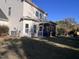 View of the home's backyard, with its screened-in porch, lawn, and trees at 374 W Falcon Ct, Clayton, NC 27520