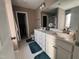 Bright bathroom with dual sinks, white cabinetry, and ample counter space at 374 W Falcon Ct, Clayton, NC 27520