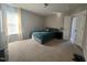Comfortable bedroom with a queen bed, natural light, and neutral decor at 374 W Falcon Ct, Clayton, NC 27520