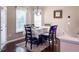 This dining room features a natural light, hardwood floors, and a six-chair dining set at 374 W Falcon Ct, Clayton, NC 27520
